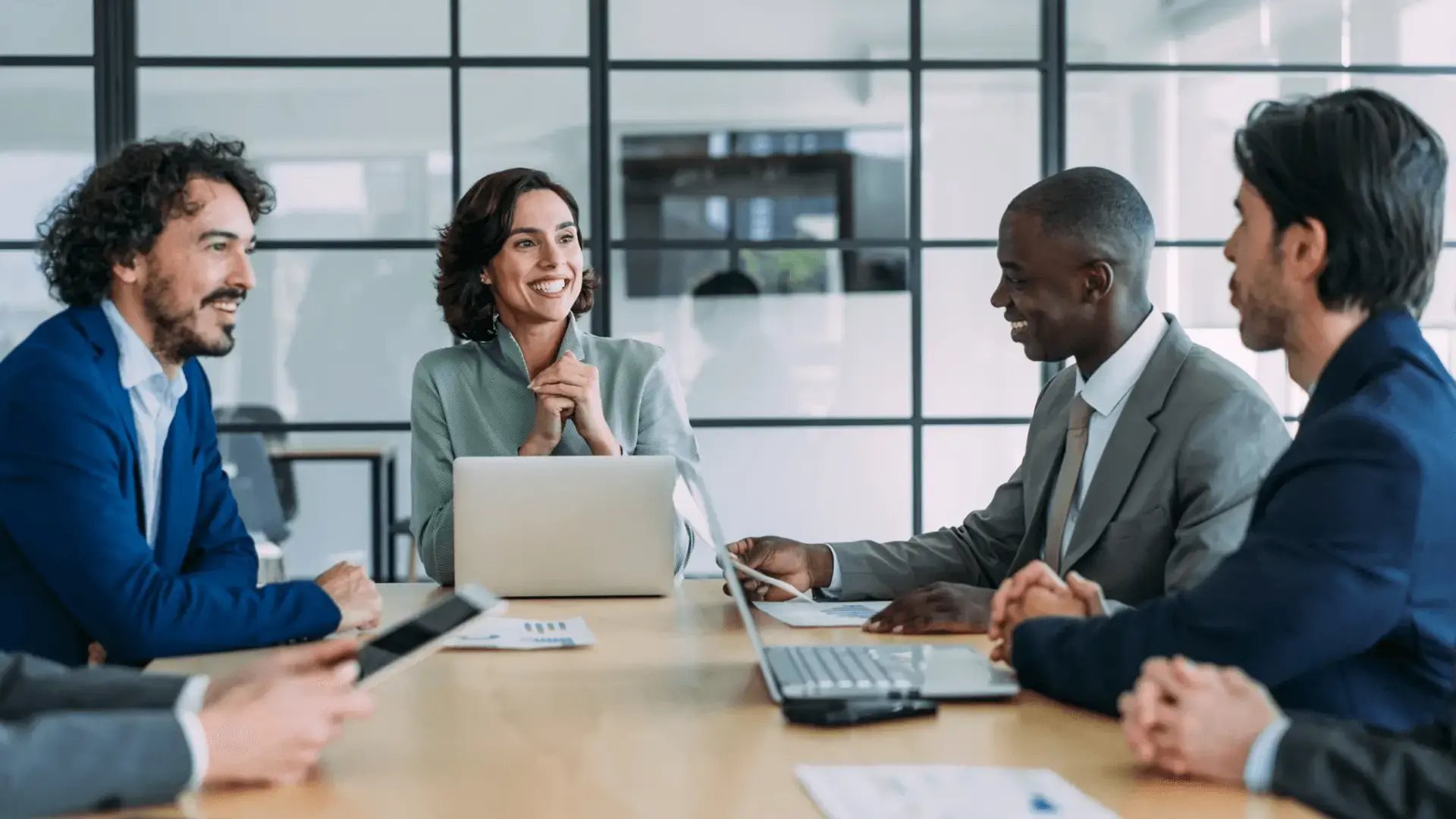 Leader engaging authentically with a diverse team in a meeting, fostering psychological safety and open communication