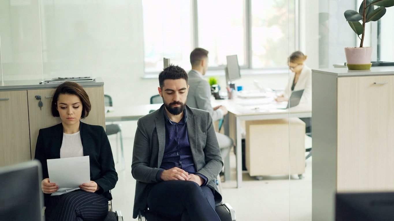 employees-waiting-outside-office