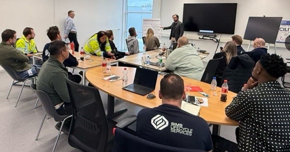 Brian Maeck discussing with Jamie Toth of GYST during a CareFactor Session with Sims Lifecycle Services employees