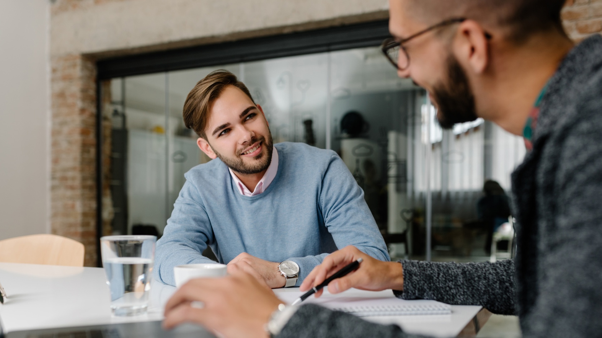 A male professional practicing active listening during an office meeting